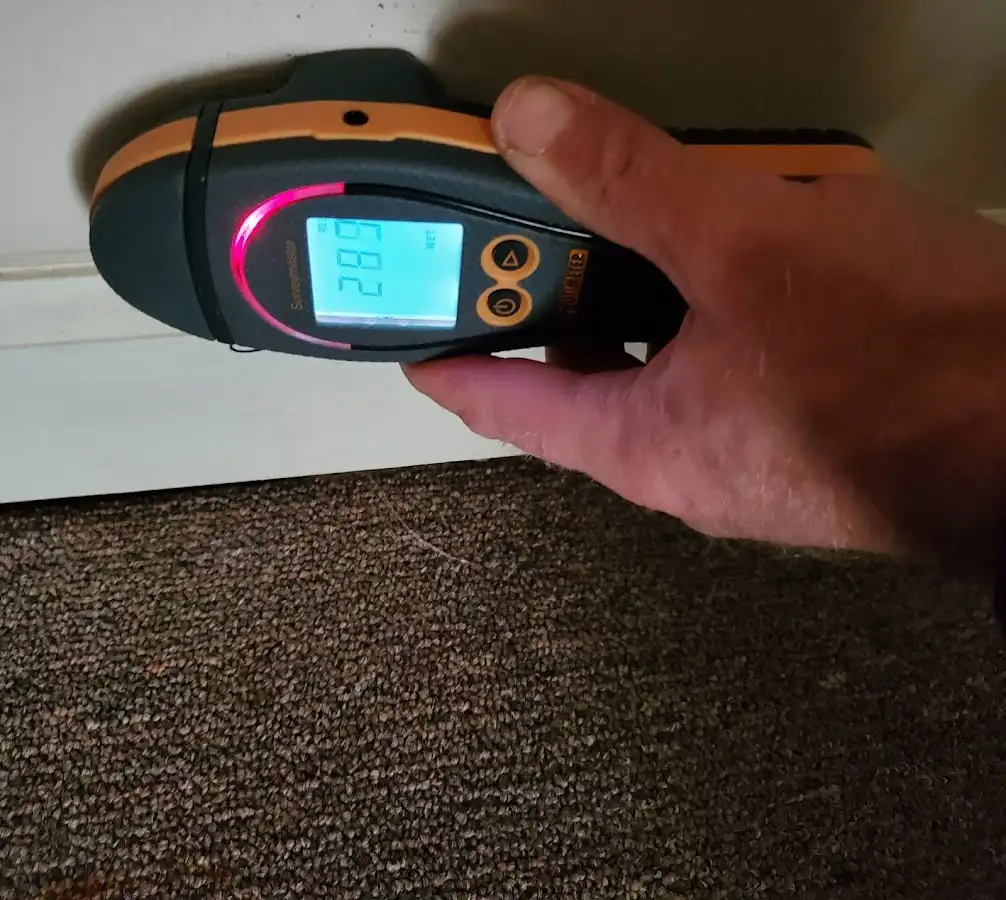Moisture detection at baseboard during Storm Damage Restoration in Marion